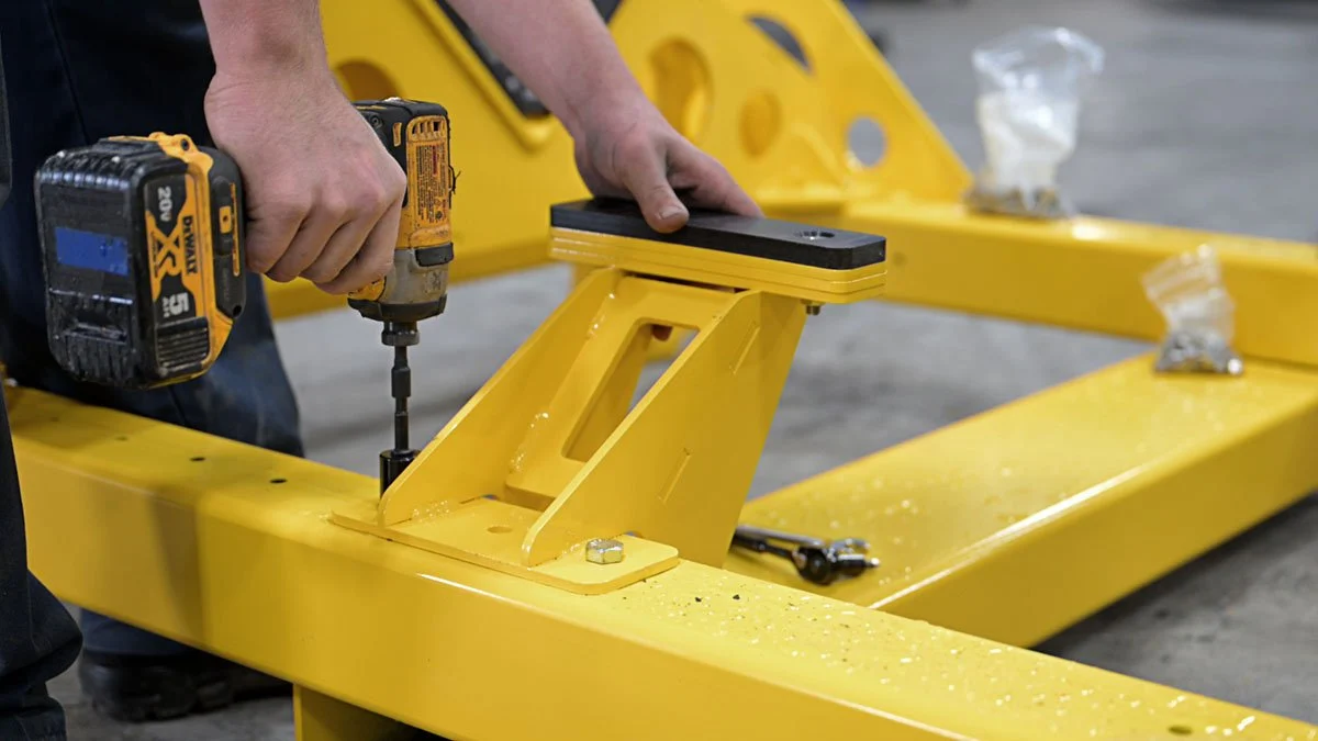 Installing hardware on a yellow coated steel frame