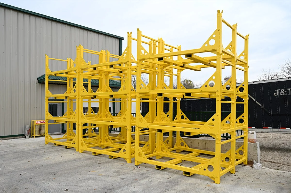 Completed yellow industrial rack assemblies outside the Mapleside facility