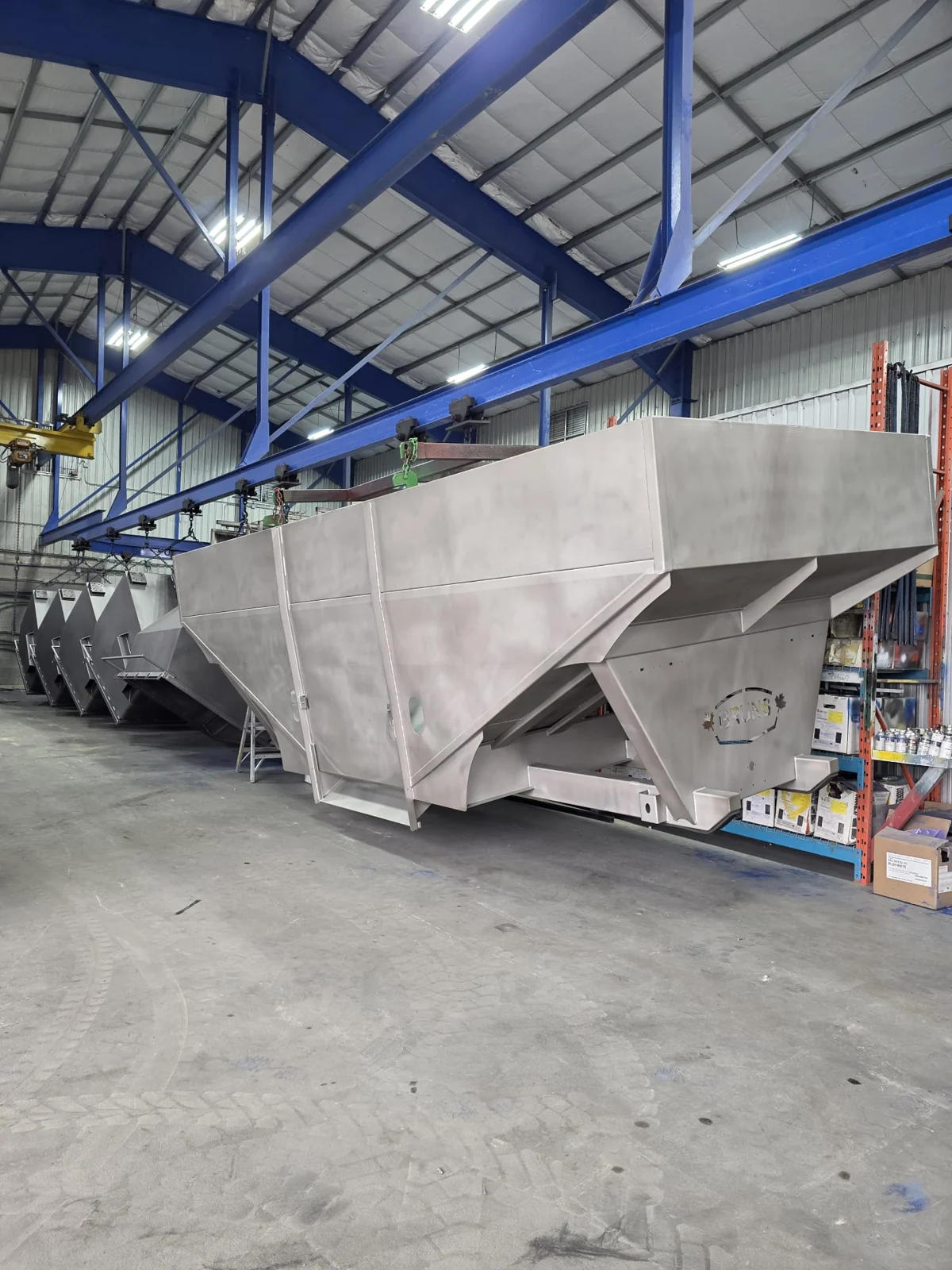 Large bare metal hopper suspended inside the facility