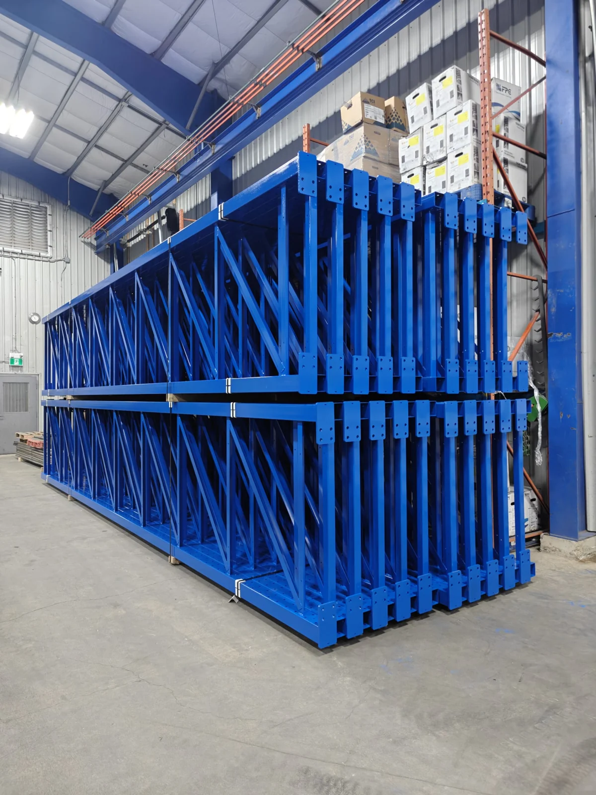 Blue coated steel racks stacked inside the facility