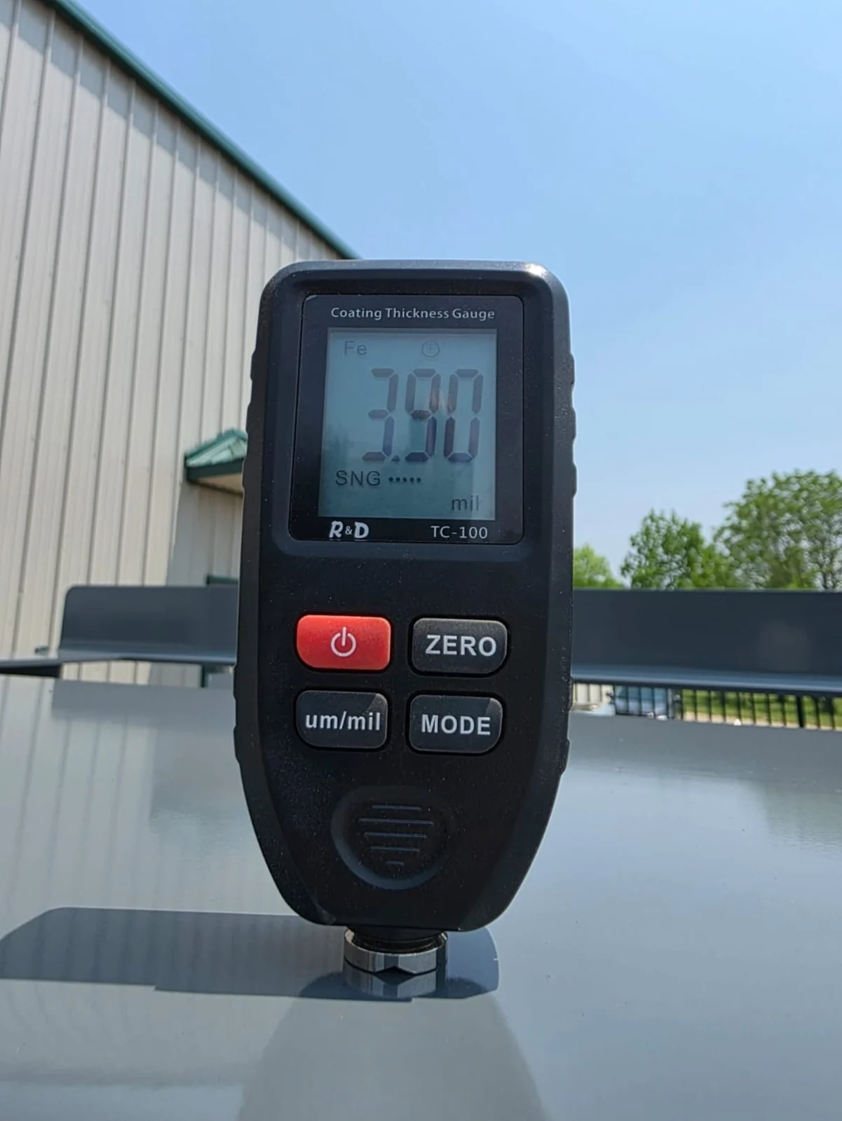 Coating thickness gauge checking a finished metal surface