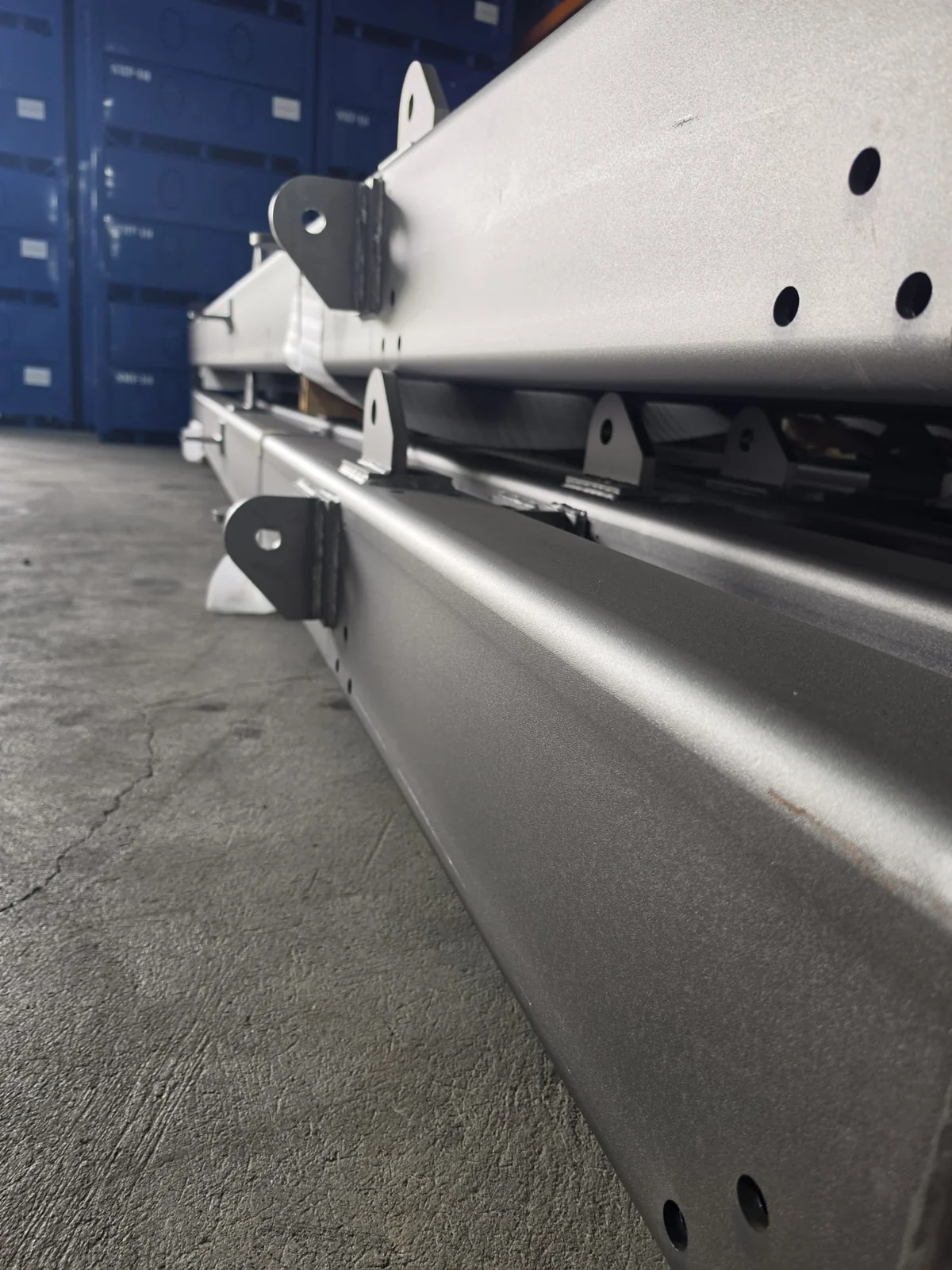 Finished gray steel components with mounting holes and brackets