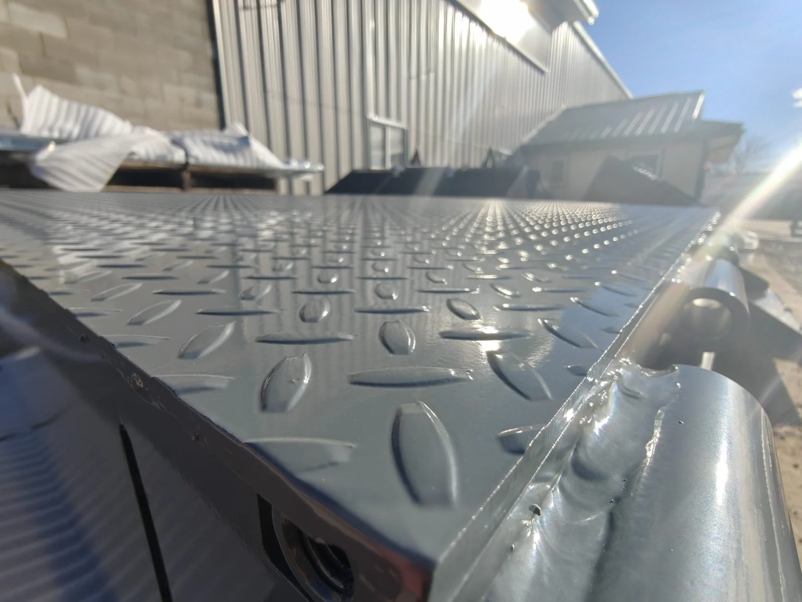 Close-up of a coated steel tread plate and welded edge