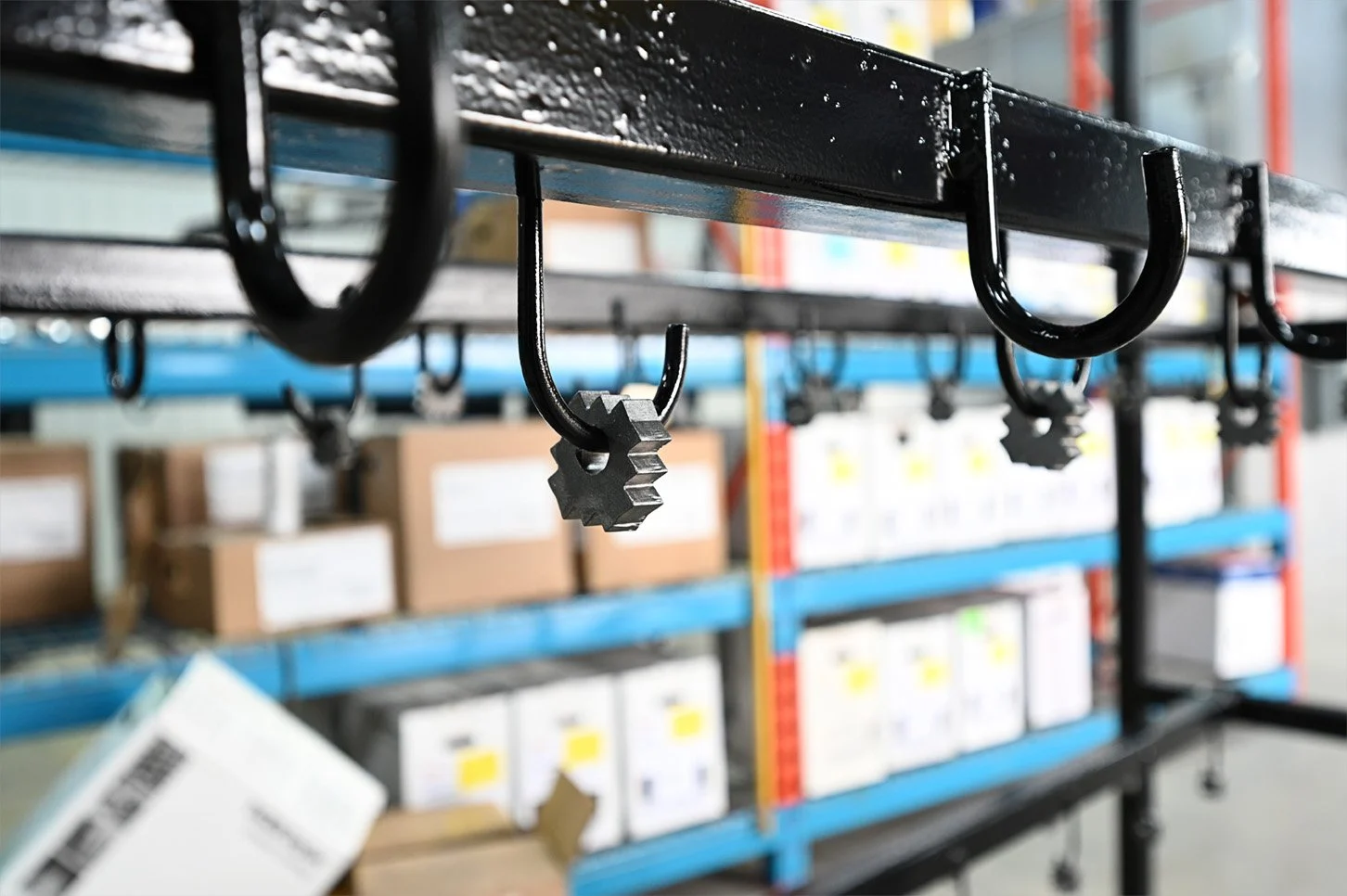 Black coated metal hooks on a hanging steel rail