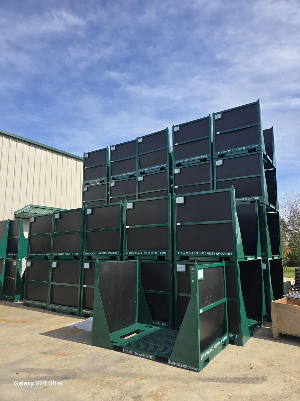 Green coated steel panels and frames staged outdoors