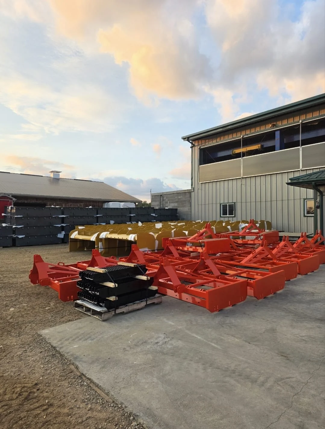 Orange coated steel fabrications staged outside the facility