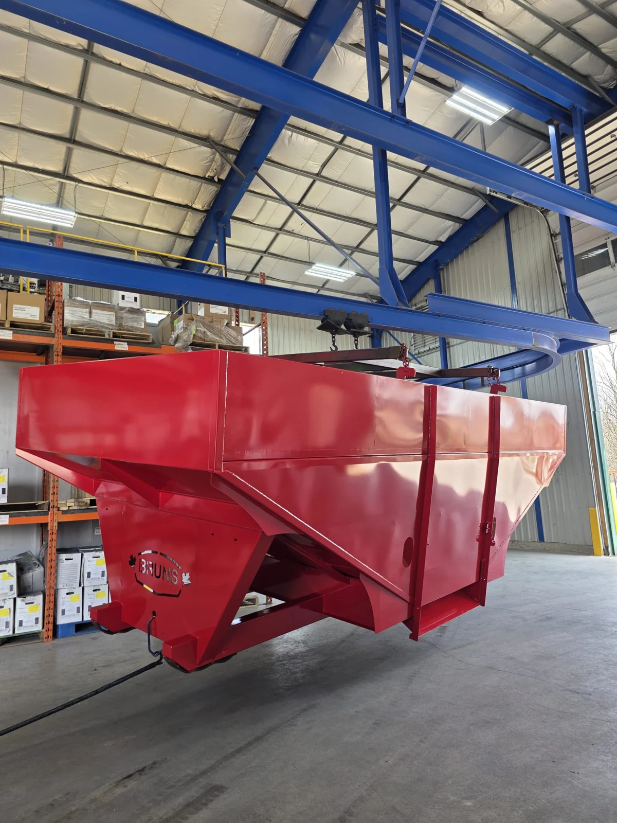 Large red coated hopper suspended inside the facility