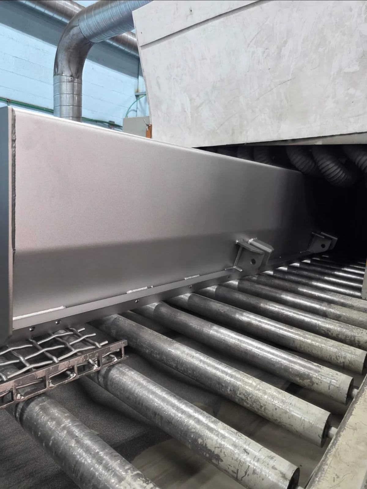Large steel section on a roller conveyor at the processing line