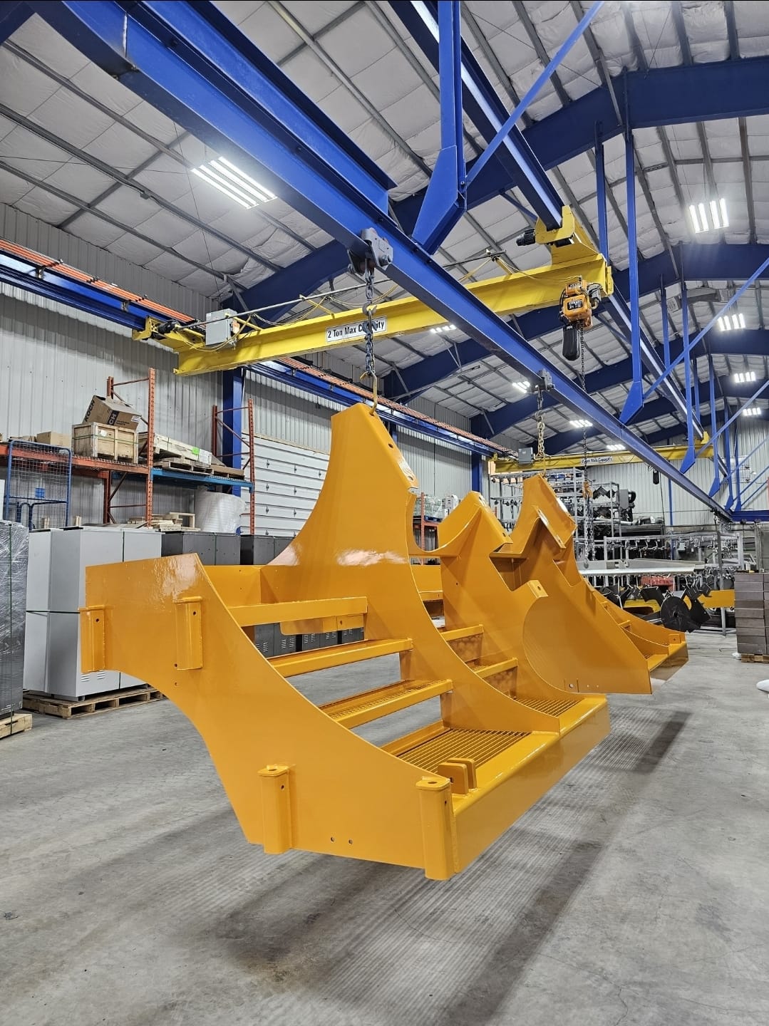 Yellow coated steel fabrication suspended inside the facility